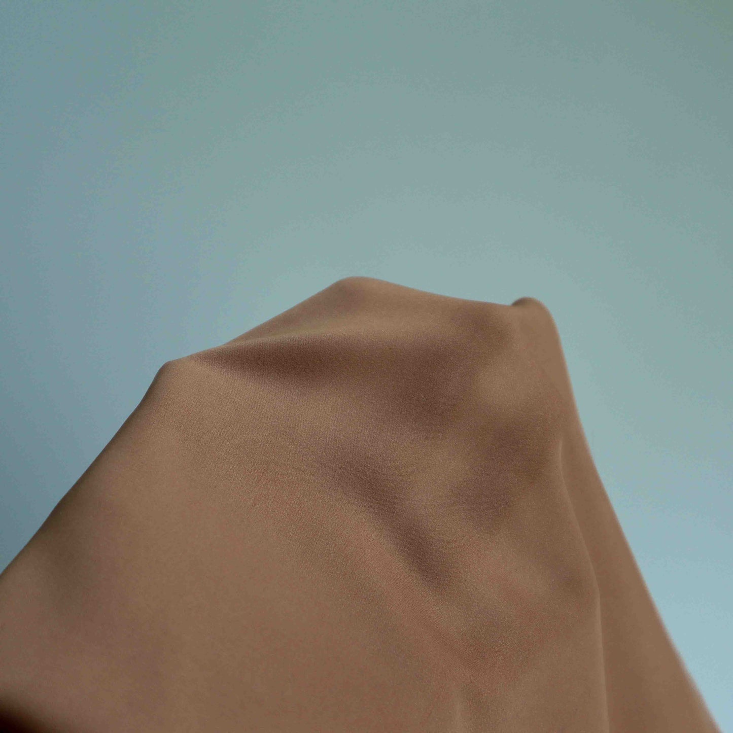 An European lightweight polyester satin in Rouge Nude. This fabric has a silky hand feel, making it smooth to the touch, elegant and light. This fabric has a matte finish, is wrinkle resistant and has no stretch.