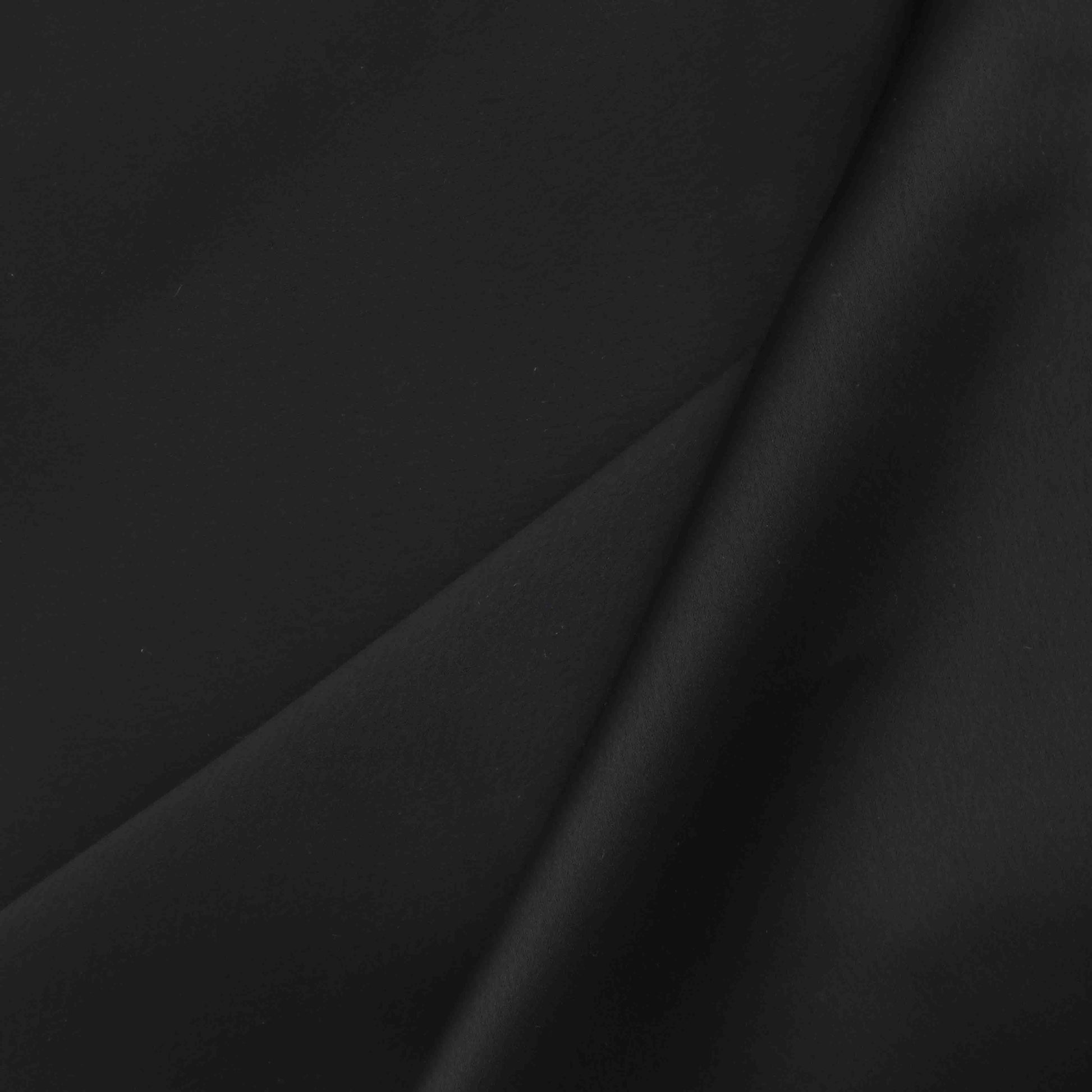 A European-made heavyweight Satin in Phantom. A beautiful fabric that has a unique silky feeling with an elegant finish. This is a double-sided fabric, with White underneath its Black exterior.