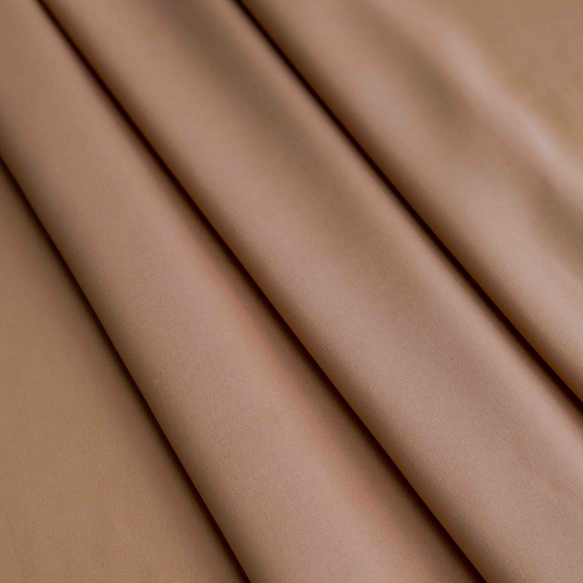 An European lightweight polyester satin in Rouge Nude. This fabric has a silky hand feel, making it smooth to the touch, elegant and light. This fabric has a matte finish, is wrinkle resistant and has no stretch.