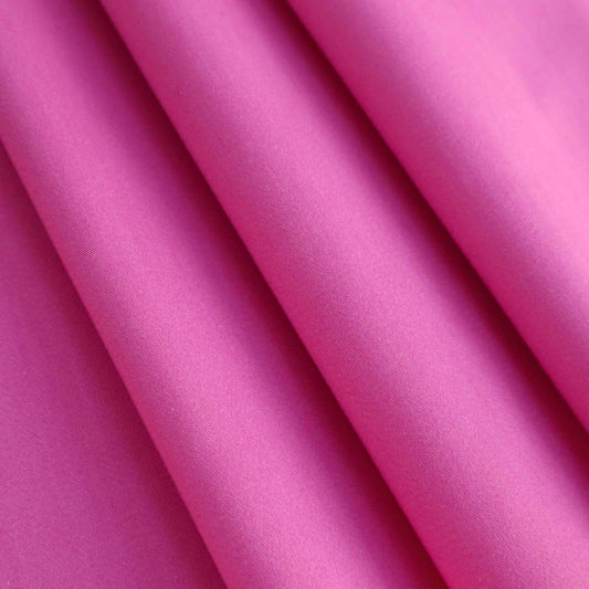 A heavyweight cotton twill in fuchsia. This fabric has a dry, smooth hand feel yet softens considerably after washing. This fluid-non stretch fabric has subtle texture throughout and matte finish.