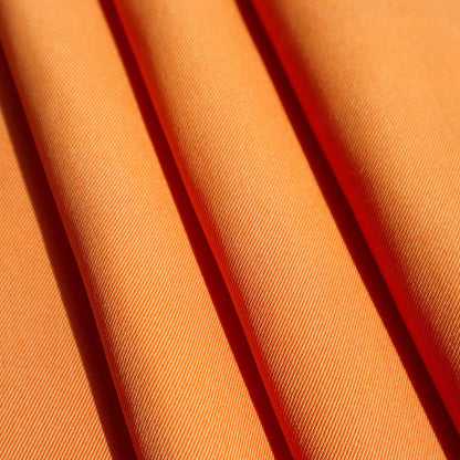 A Mid-weight twill in Saffron. This fabric has a dry, smooth hand feel yet softens considerably after washing. This fluid-non stretch fabric has subtle texture throughout and matte finish.