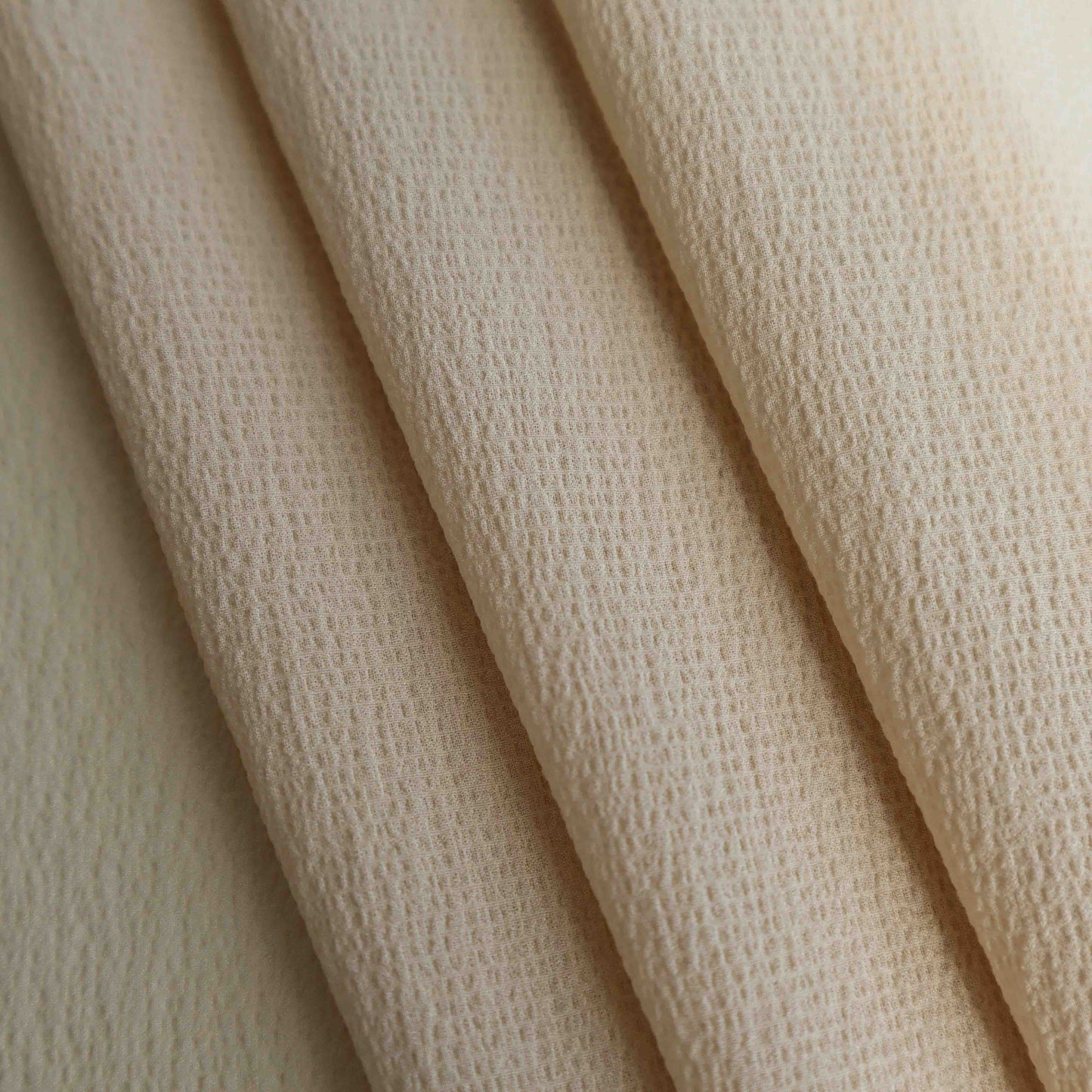 An European-made lightweight silk crepe in natural Shell. This fabric has a dry, smooth hand feel yet softens considerably after washing. This fluid-non stretch fabric has subtle texture throughout and matte finish.