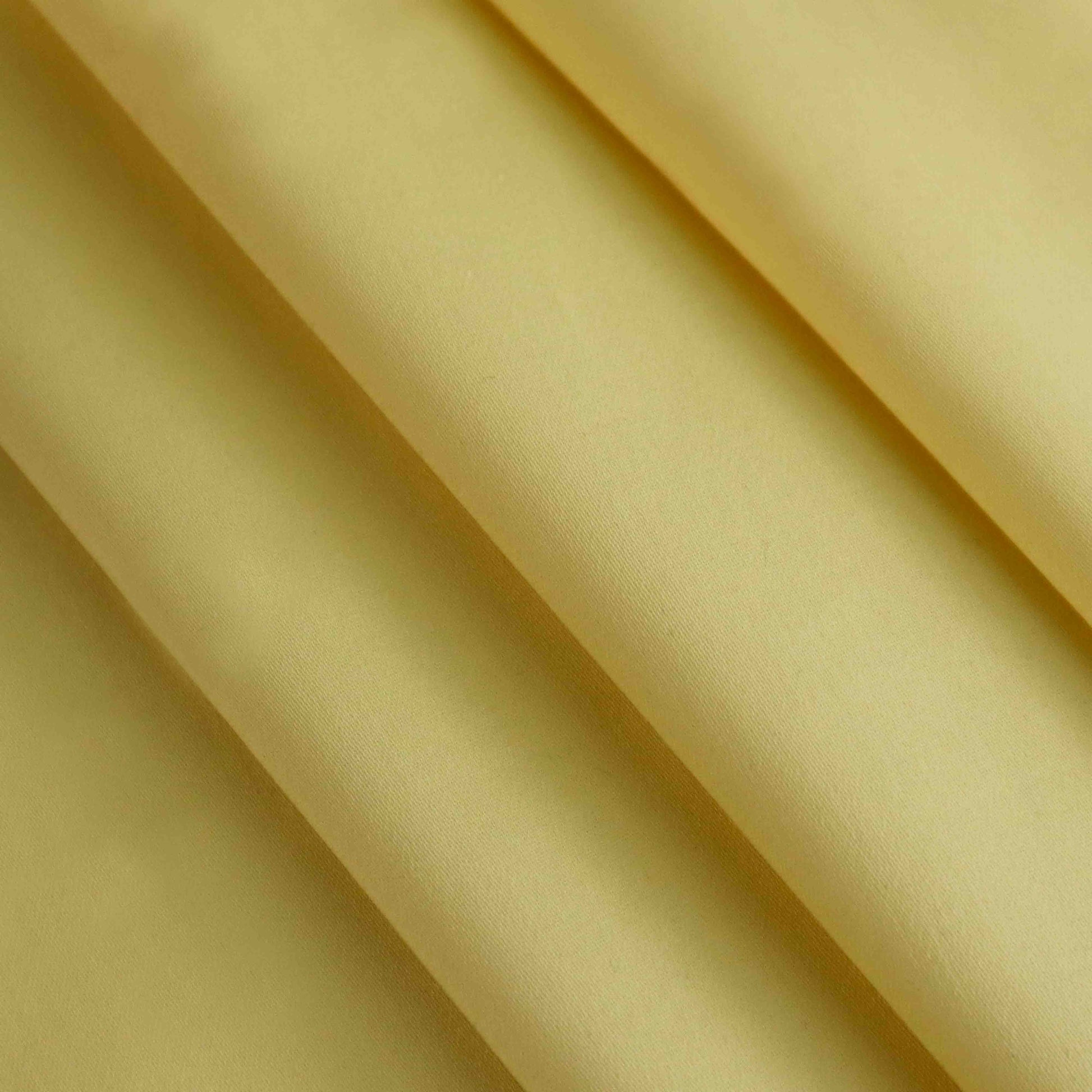 A Japanese-made lightweight cotton satin in Lemon. This fabric has a dry, smooth hand feel yet softens considerably after washing. This fluid-non stretch fabric has subtle texture throughout and matte finish.