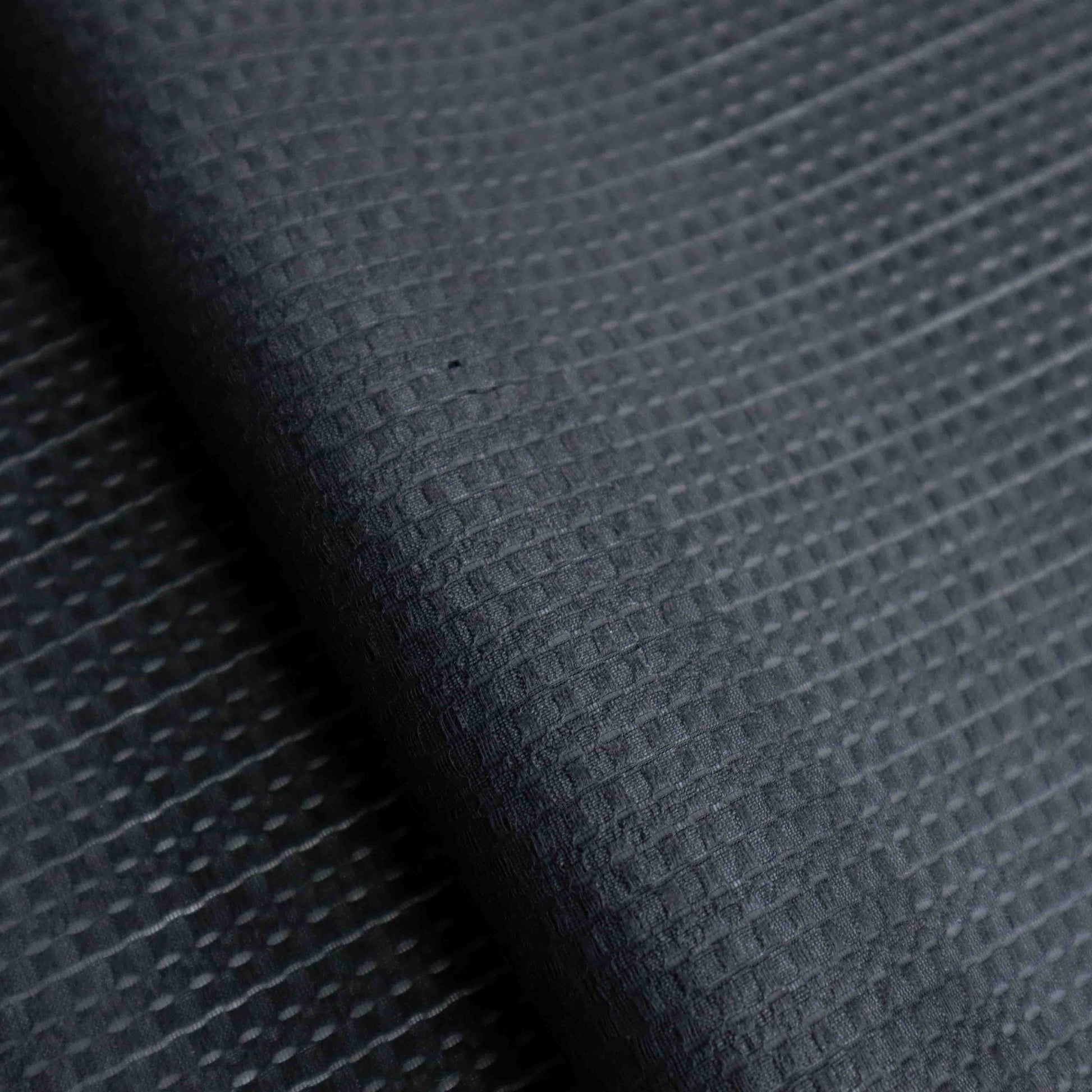 An European-made lightweight polyester silk in Black Caviar. Composing of neatly arranged black small squares, this almost opaque fabric is extremely comfortable and breathable. This fabric has a dry, smooth hand feel yet softens considerably after washing.