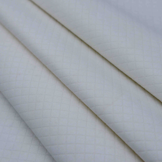 A mid-weight textured fabric in Porcelain. This fabric has a quilt look-a-like texture to it and is stretchable due to the spandex blend in fabric composition. It is breathable despite its weight.